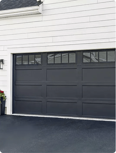 Contemporary black panel garage door matching a modern custom closet design aesthetic