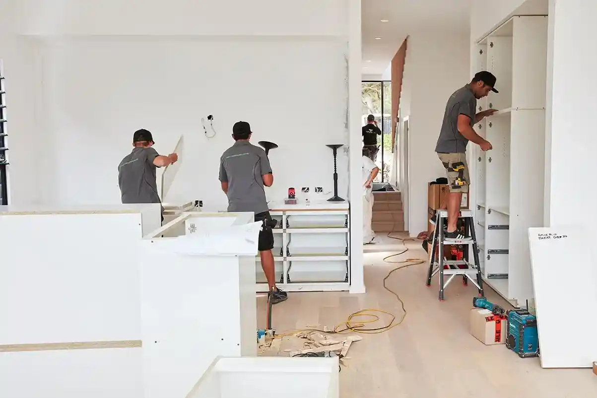 Remodeling crew installing drywall in a modern home renovation project.