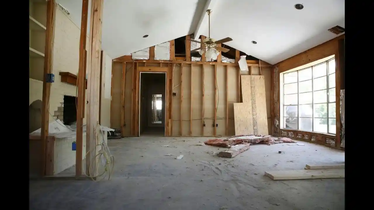 Contractors working inside the wood framing of a new home remodel.