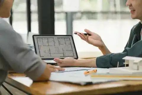 Home design consultation services reviewing renovation plans with homeowners